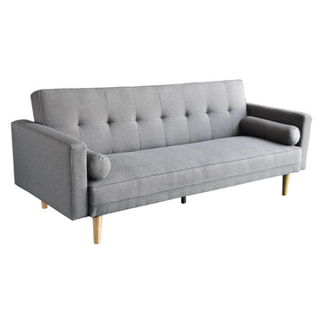 Light grey tufted linen sofa bed with cylindrical bolster cushions and tapered wooden legs on white background