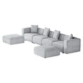 Light grey modular 4-seater sofa with left and right ottomans, angle view on white background