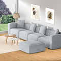 Light grey modular 4-seater sofa with ottoman in bright living room with garden window view