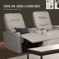 Two light grey PU recliners side by side, left one footrest extended with dark cushion, dark wall background