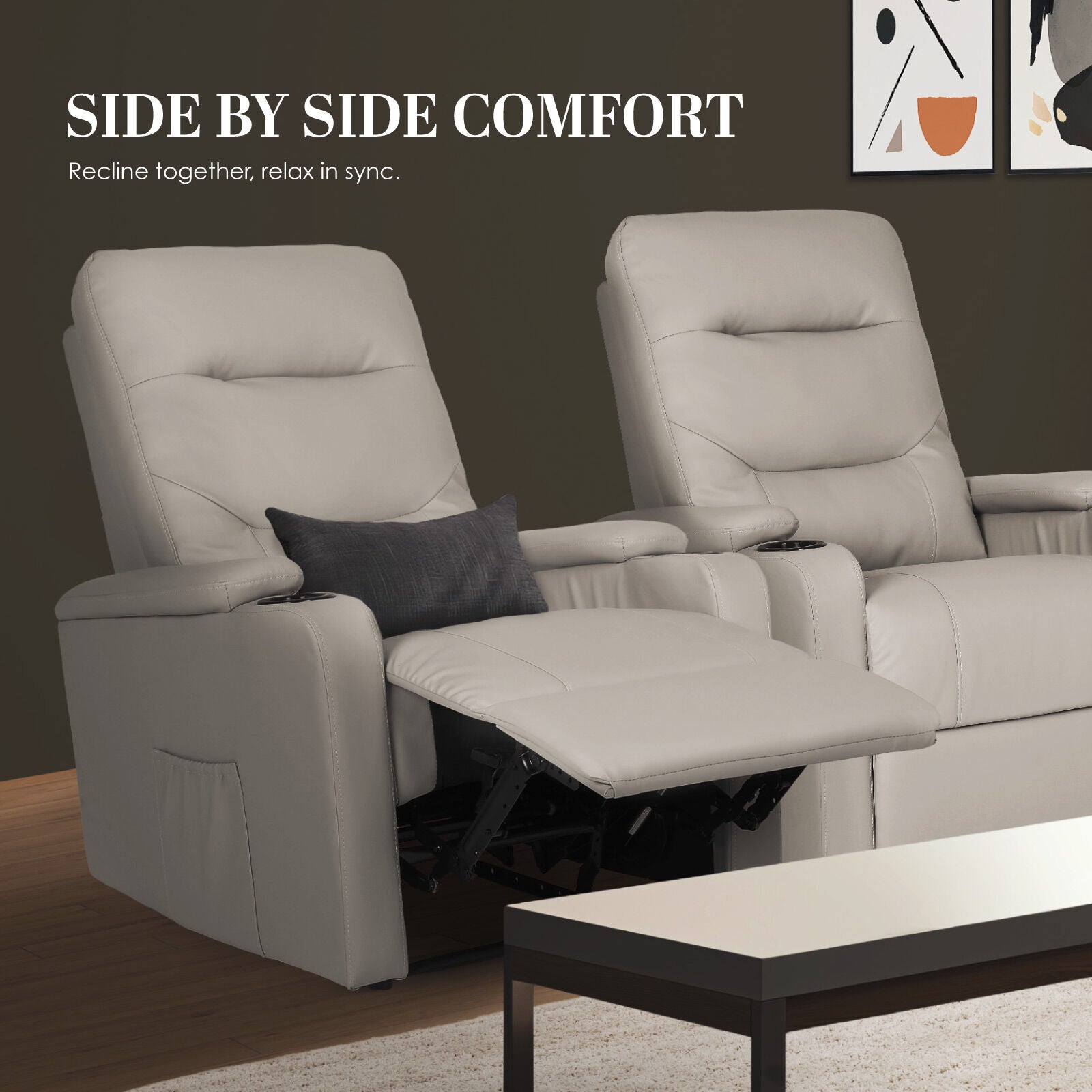 Two light grey PU recliners side by side, left one footrest extended with dark cushion, dark wall background