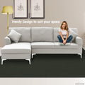 Light grey fabric sectional sofa with chaise and white metal legs with woman seated in living room