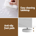 Feature panel: easy cleaning tabletop shown with water wipe, and anti-slip adjustable foot pads close-up, text labels visible