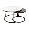 Two round nesting coffee tables with white marble and black marble tops on bronze metal ring bases on white background