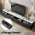 Black marble-top TV unit four drawers open 58x24x10cm with books and decor on marble top and wall-mounted TV