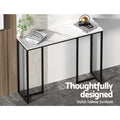 Marble-top console desk top-angle view in hallway, styled with magazines and decor; text 