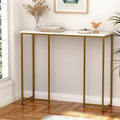 Console table with white marble-effect top and gold metal frame in room corner, styled with dried flowers and books