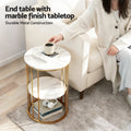 Round end table with marble finish top and gold cage frame beside armchair, text: End table with marble finish tabletop