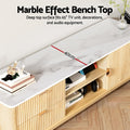 White marble-top TV unit bench top detail 40cm deep fits 65-inch TV with Nintendo Switch and headphones on center shelf