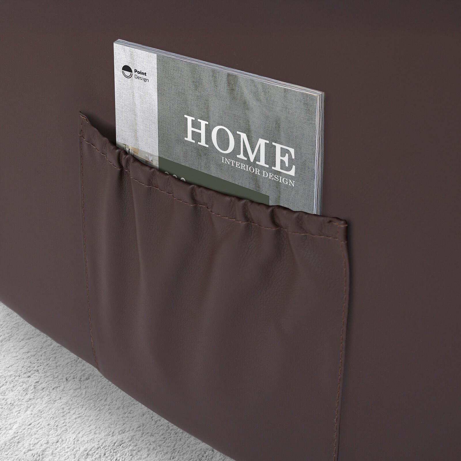 Close-up of dark brown PU leather recliner side pocket with a Home Interior Design magazine inserted