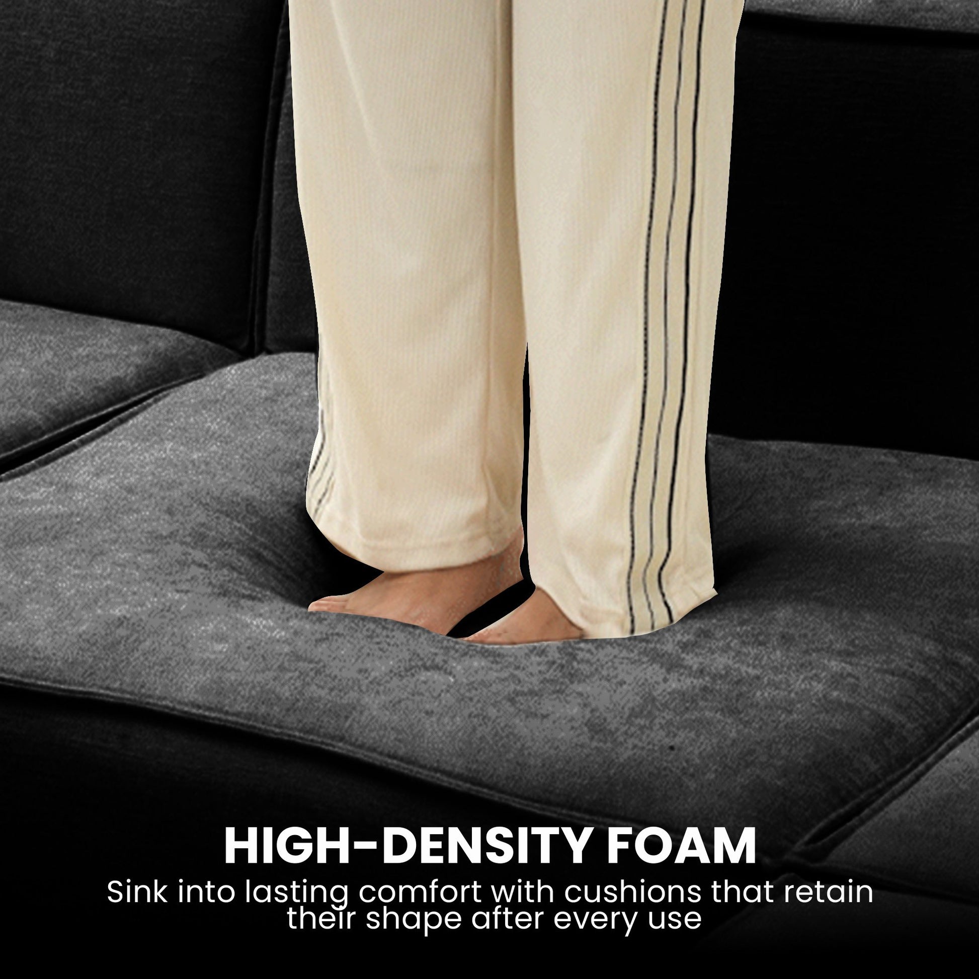 Person's bare feet standing on dark charcoal sofa cushion with HIGH-DENSITY FOAM text overlay