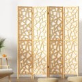 Natural pine 4-panel criss-cross geometric cutout room divider in lifestyle room with plant and round floor cushions