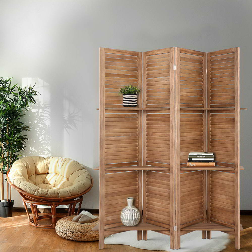 Natural 4-panel louvered wood room divider with shelves in lifestyle room with papasan rattan chair bamboo plant and vase