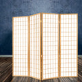 Natural pine 4-panel grid shoji room divider in room with dark stone textured wall and reflective floor