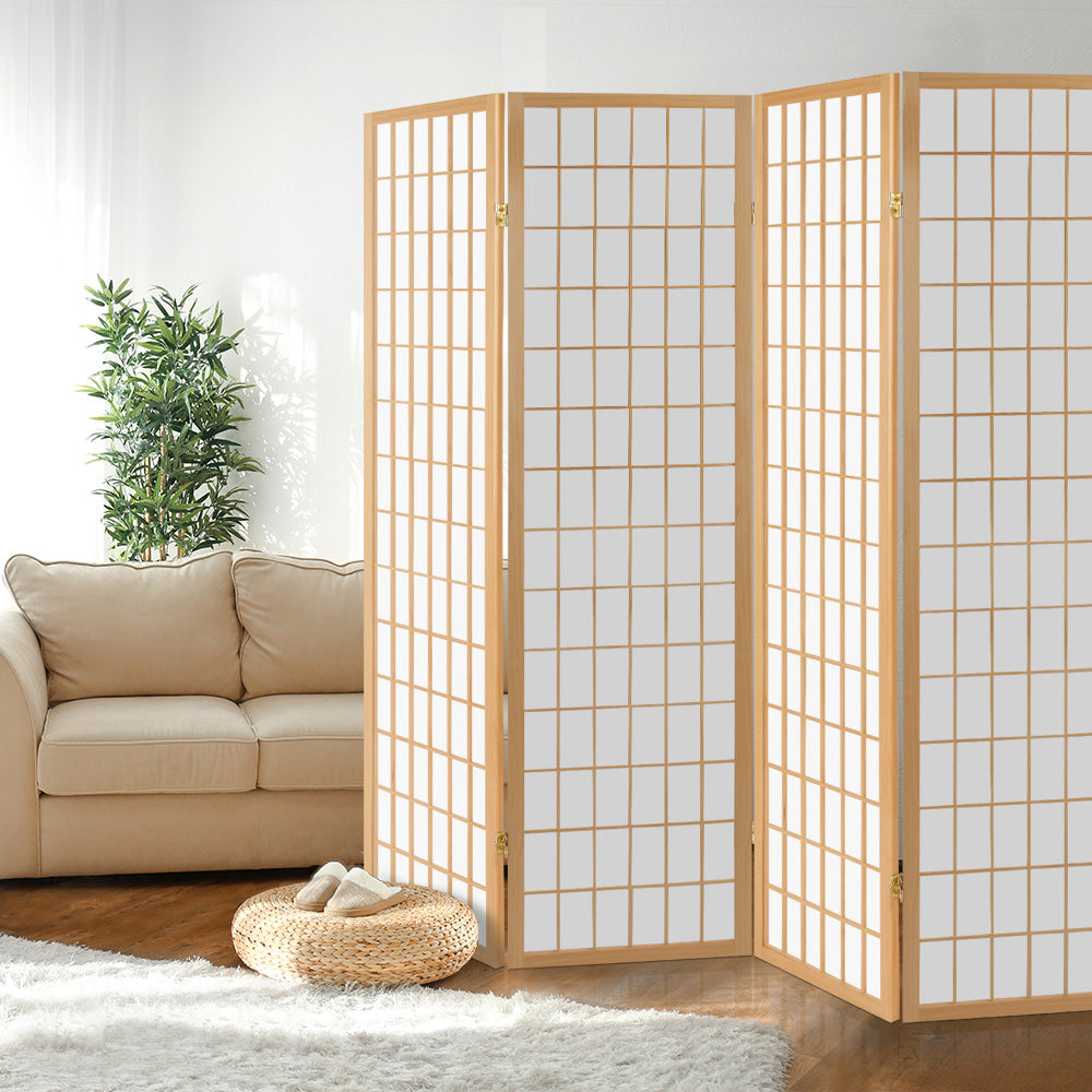 Natural pine 4-panel fabric grid shoji room divider in lifestyle room with cream sofa bamboo plant wicker pouf and wood floor