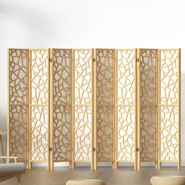 Natural pine 8-panel geometric MDF room divider with cutout pattern in lifestyle room with chair and ottomans