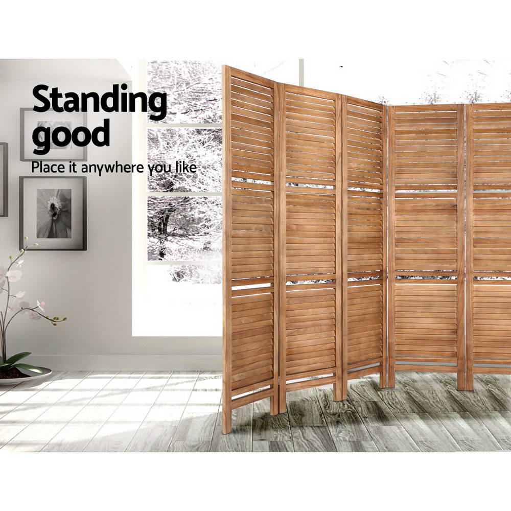 Natural 8-panel louvered wood room divider with shelves in lifestyle room with orchid plant framed art and light wood floor