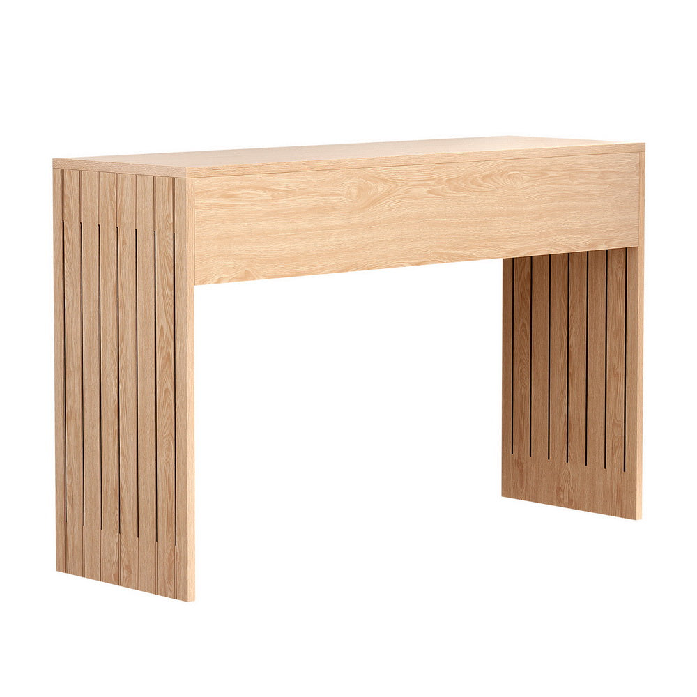 Natural oak console table with vertical slat wood side panels, flat top and open base, three-quarter angle on white background