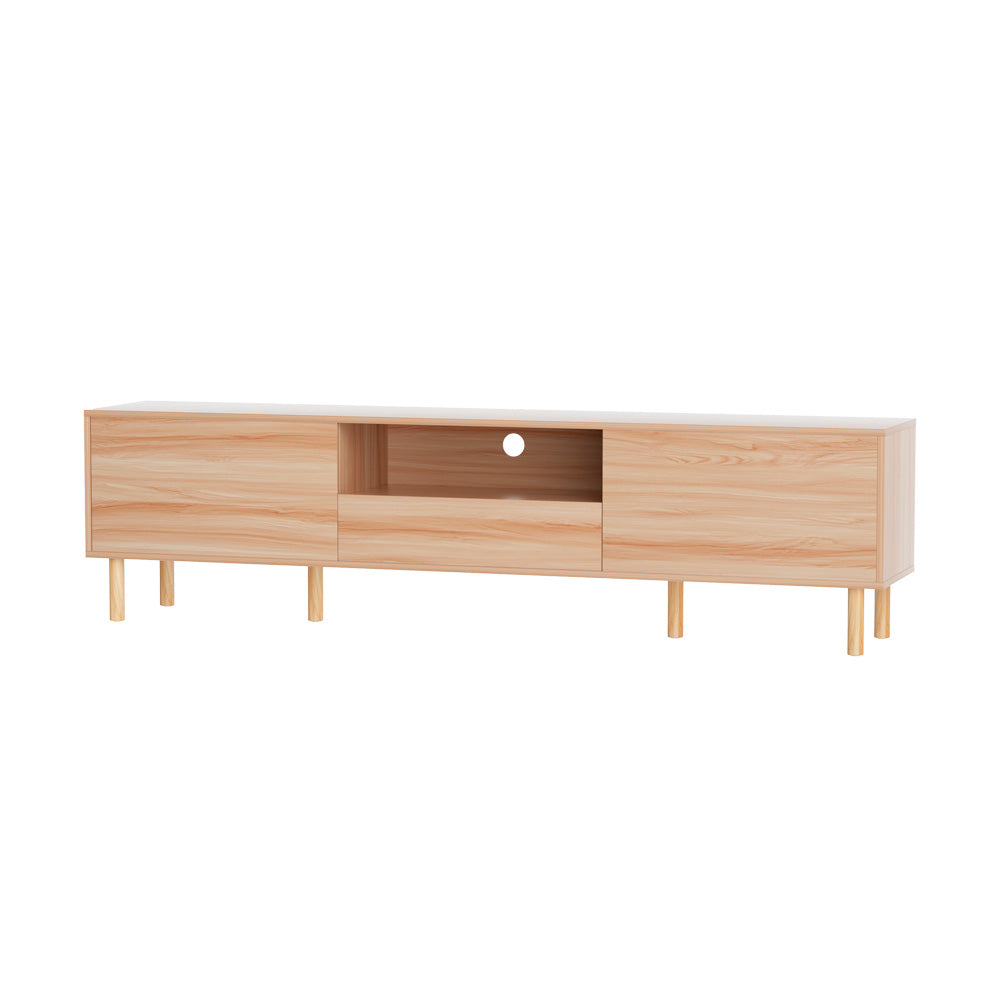 Natural pine TV unit 180cm angle view on white two side doors center open shelf cable hole drop-down drawer round legs