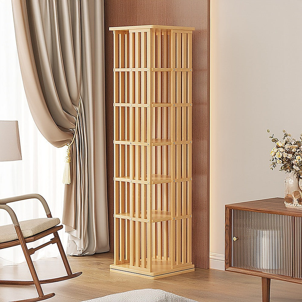 Natural wood slat-sided rotating tower bookshelf with 5 tiers, empty, three-quarter angle view on white background