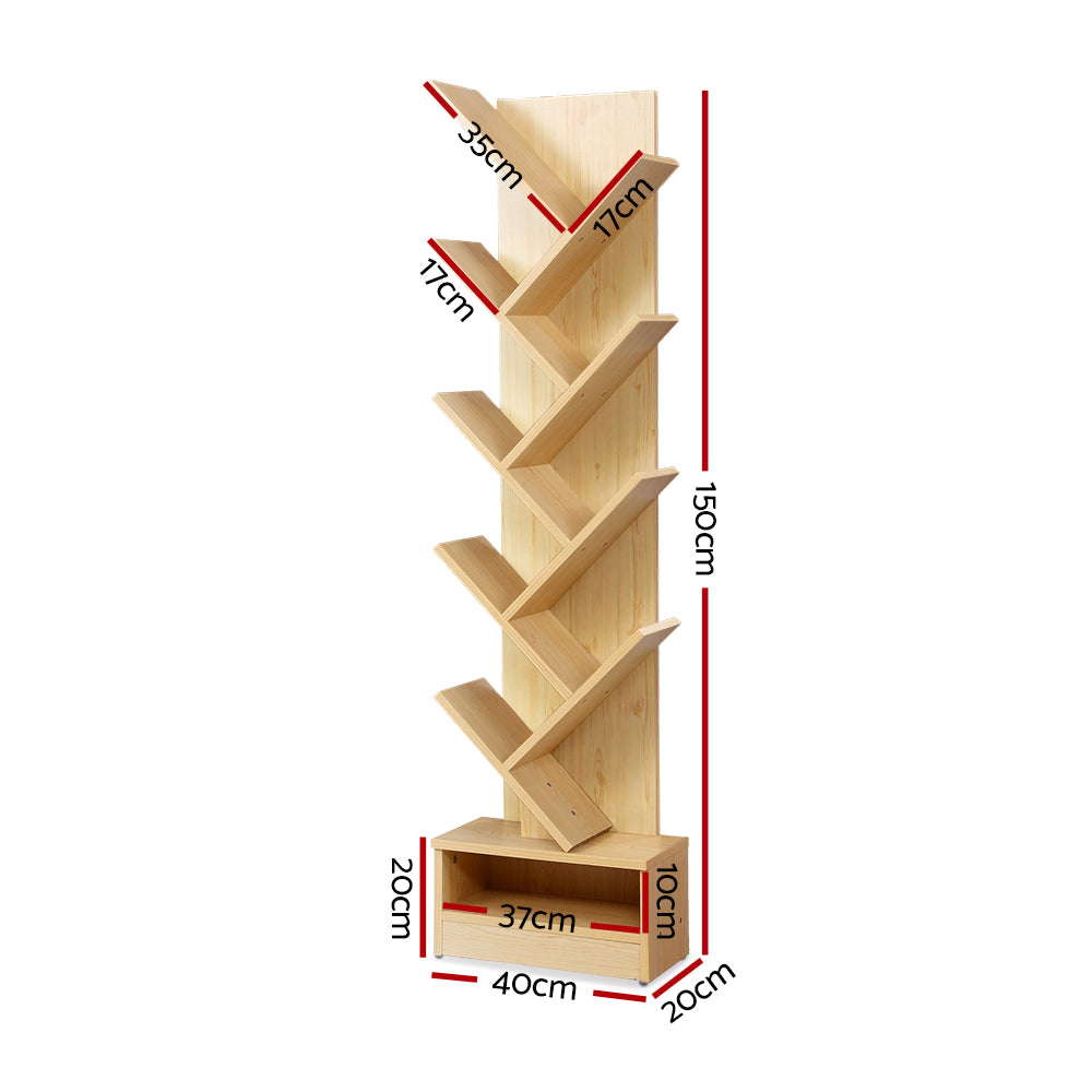 Natural wood tree-shaped bookshelf filled with books in living room lifestyle with small round side table and plant
