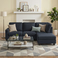 Dark navy fabric sectional sofa with chaise in living room with white brick fireplace and patterned rug