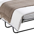 Close-up of navy sofa bed pull-out showing black metal folding frame, white mattress edge and brown throw blanket