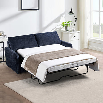 Navy blue textured fabric sofa bed extended in bedroom lifestyle with plant, white mattress and brown throw blanket