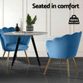 Pair of navy blue velvet shell-back armchairs at round marble dining table with 150kg max load badge overlay