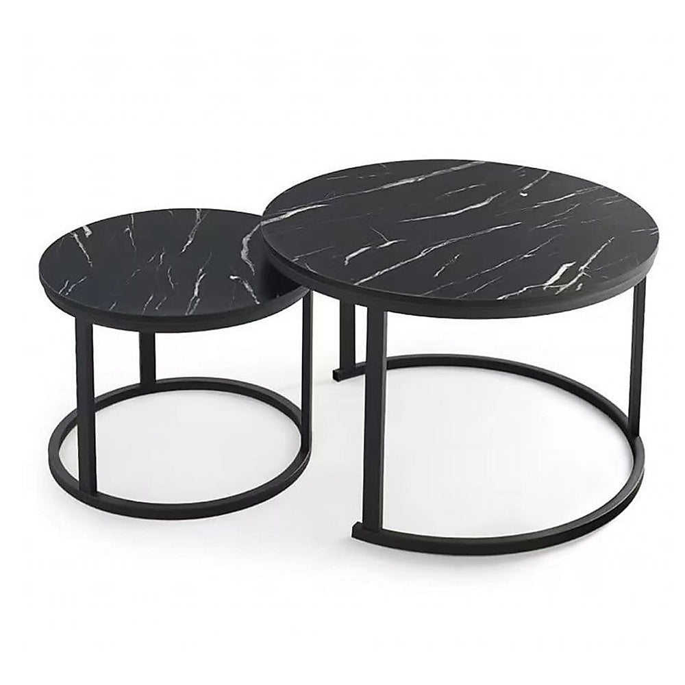 Two round nesting coffee tables with black marble-pattern tops on black metal ring bases, set shown on white background