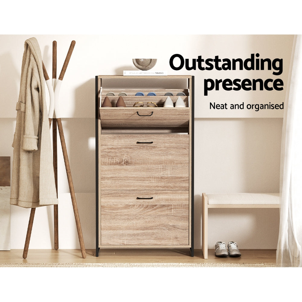 Oak three-tier shoe cabinet with black metal frame top door open showing stored shoes in hallway lifestyle with coat rack
