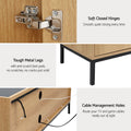Oak and black TV unit soft-close hinges tough metal legs with anti-scratch pads and cable management holes close-up