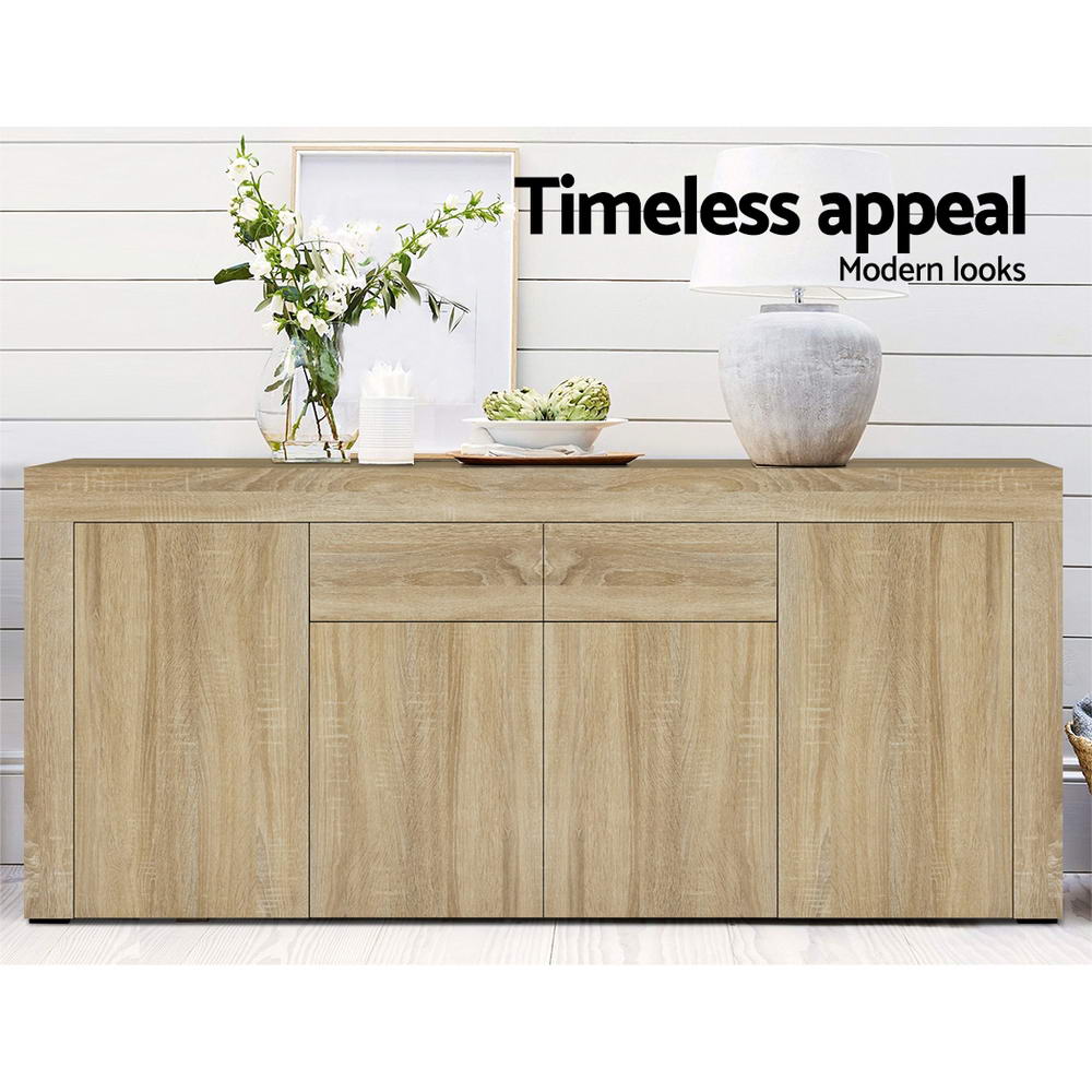 Oak buffet sideboard in room with flowers in vase, artichokes and lamp on top; text: timeless appeal, modern looks