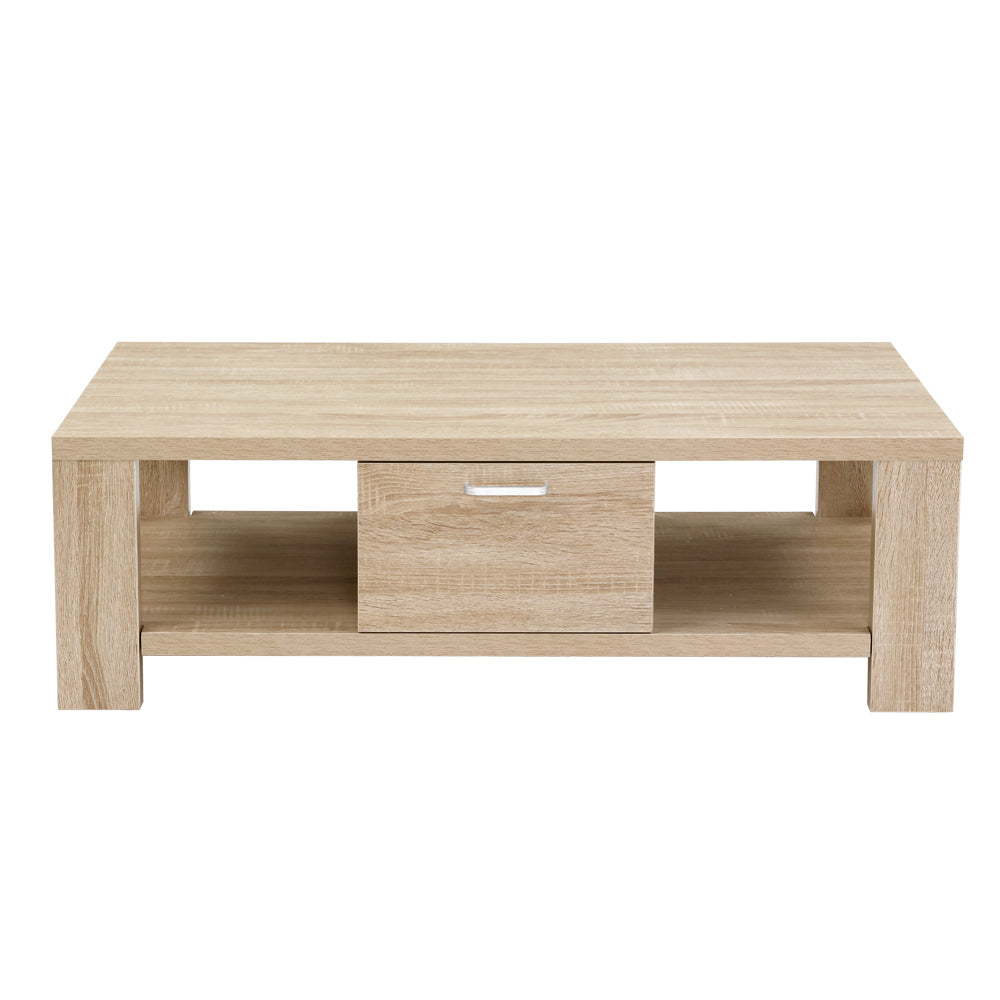 Light oak coffee table front view showing central drawer with silver handle and open side shelves