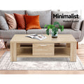 Light oak coffee table with drawer in front of grey sofa with terracotta cushions, text Minimalist Modern appeal