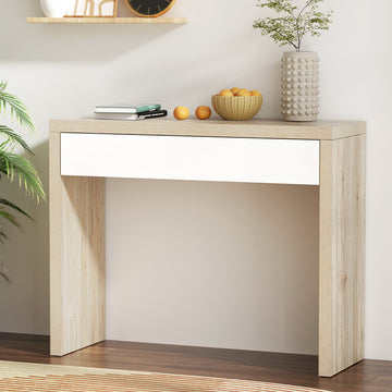 Oak console table with white drawer in room, styled with books, fruit bowl and textured vase