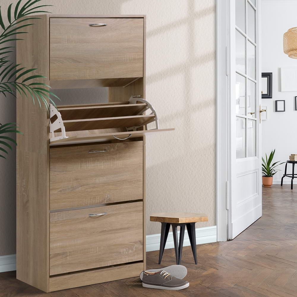 Oak 4-door flip shoe cabinet in hallway, one middle door open showing interior rack mechanism, plant and stool visible
