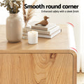 Close-up of oak sideboard rounded corner with vase, candle and books on top, text reads Smooth round corner
