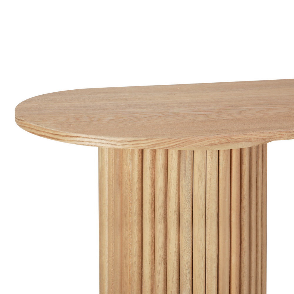 Close-up of oval oak console tabletop edge and fluted cylindrical column base, natural wood grain, white background