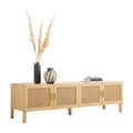Oak and rattan TV unit angle view on white pampas grass in tall dark vase small striped vase and books on top