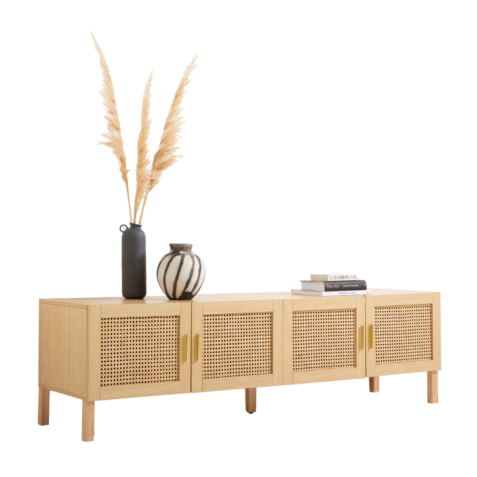 Oak and rattan TV unit angle view on white pampas grass in tall dark vase small striped vase and books on top