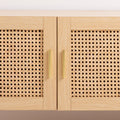 Oak and rattan TV unit close-up of two cane-weave door panels with gold bar handles on light oak frame