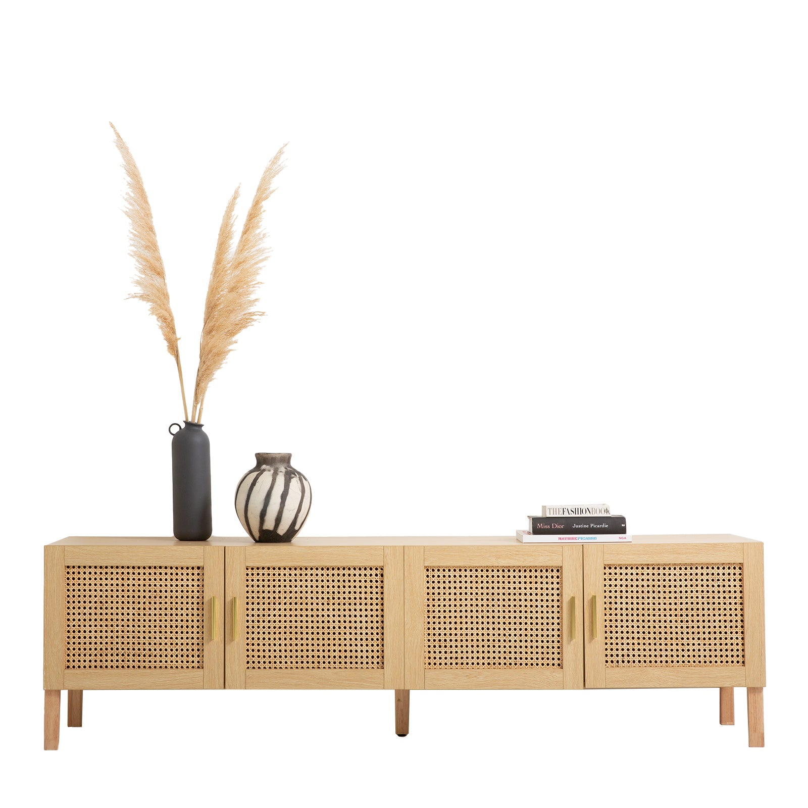 Oak and rattan TV unit on white with pampas grass tall dark vase striped vase and stacked fashion books on top