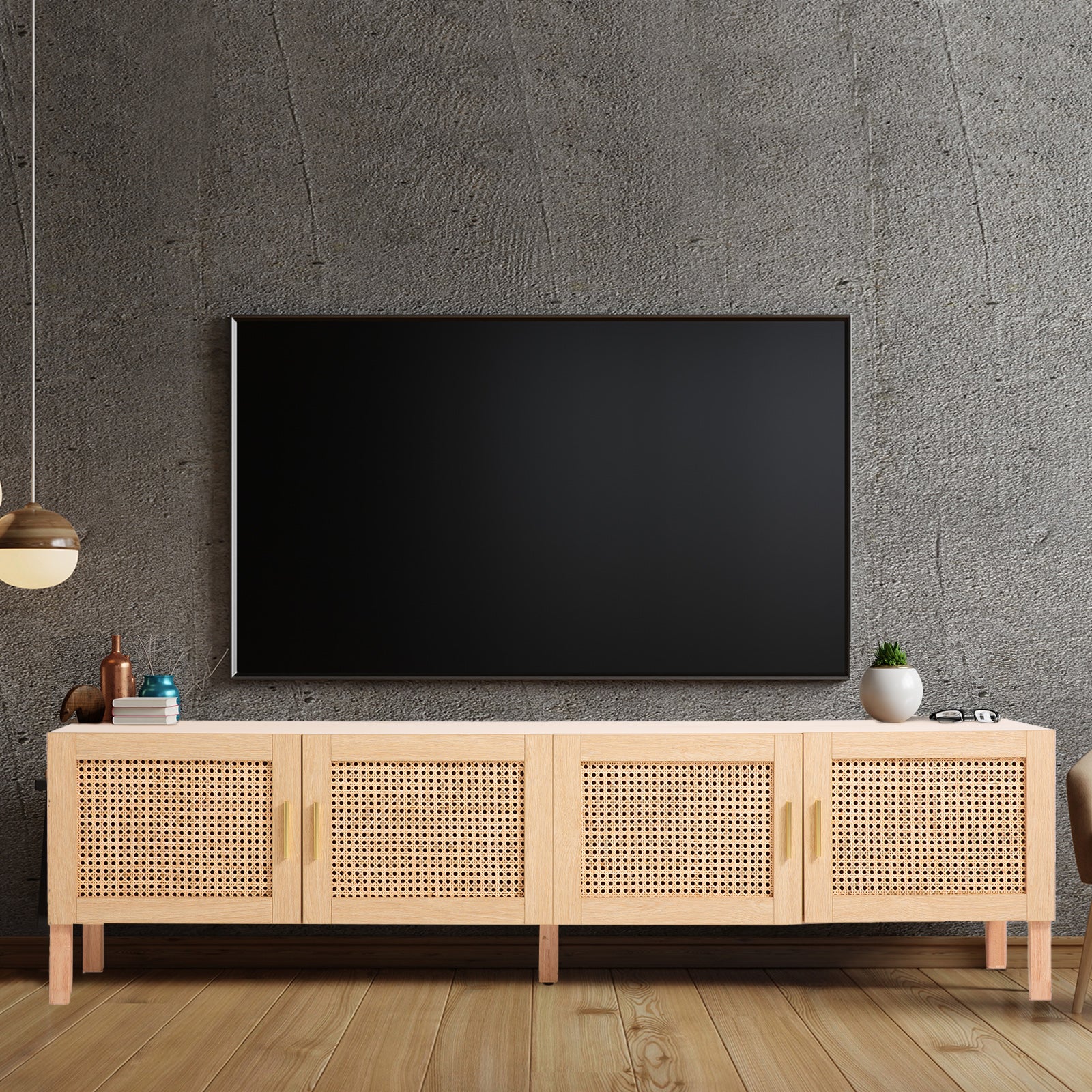 Oak and rattan TV unit in grey concrete room with wall-mounted TV pendant light copper mug and small plant