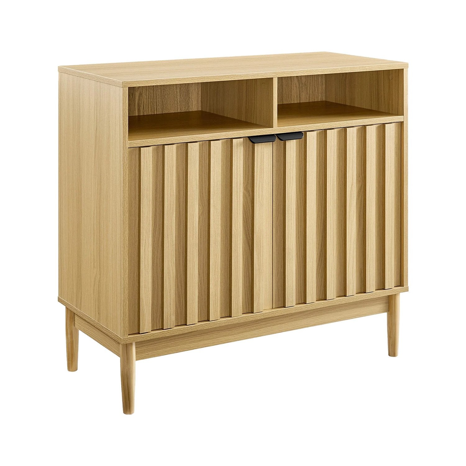 Natural oak reeded cabinet angled view, two open top compartments and two lower reeded doors with black handles, tapered legs