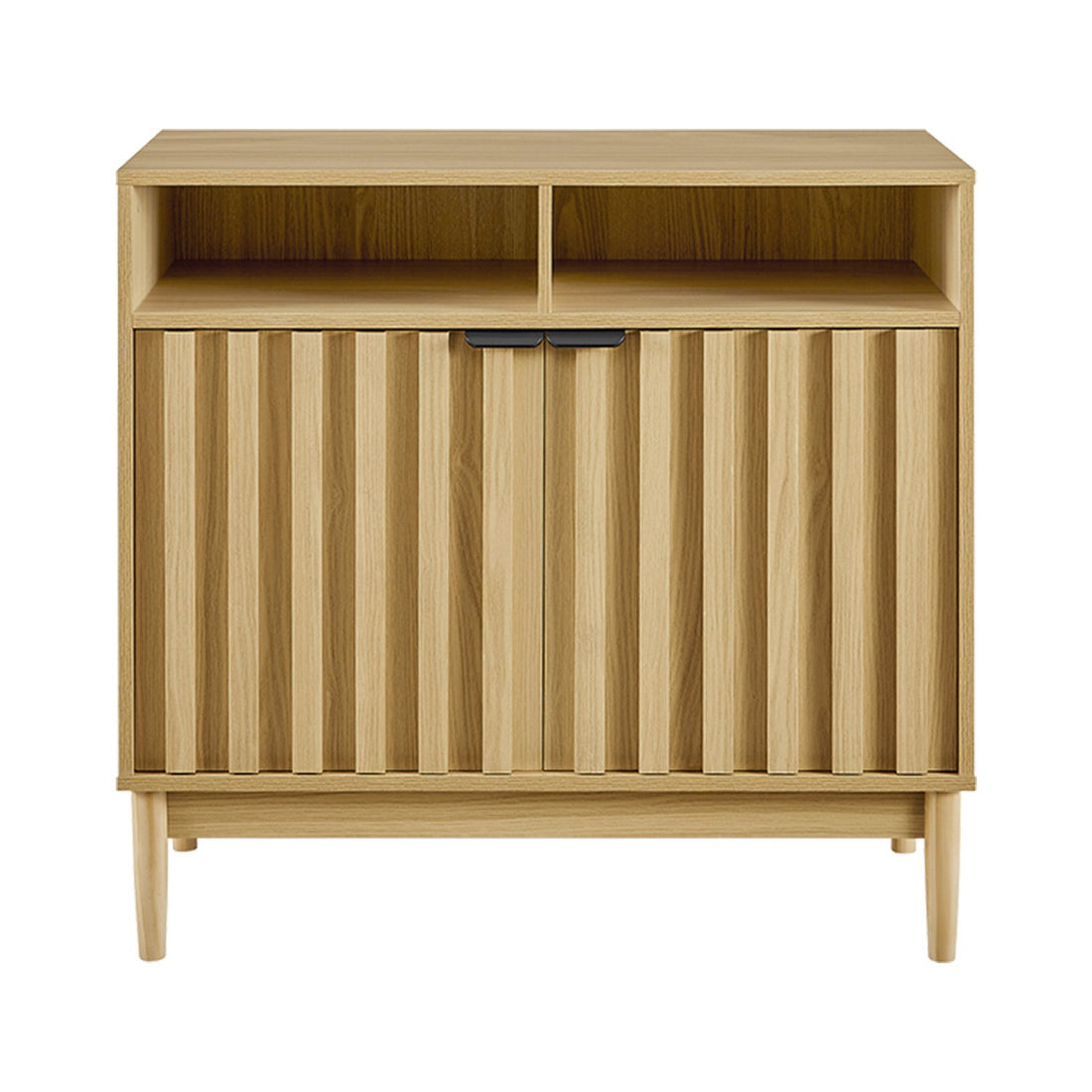 Natural oak reeded cabinet angled view, two open top compartments and two lower reeded doors with black handles, tapered legs
