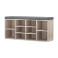 Oak shoe storage bench with grey cushion three-quarter view all 10 open cubbies empty on white background