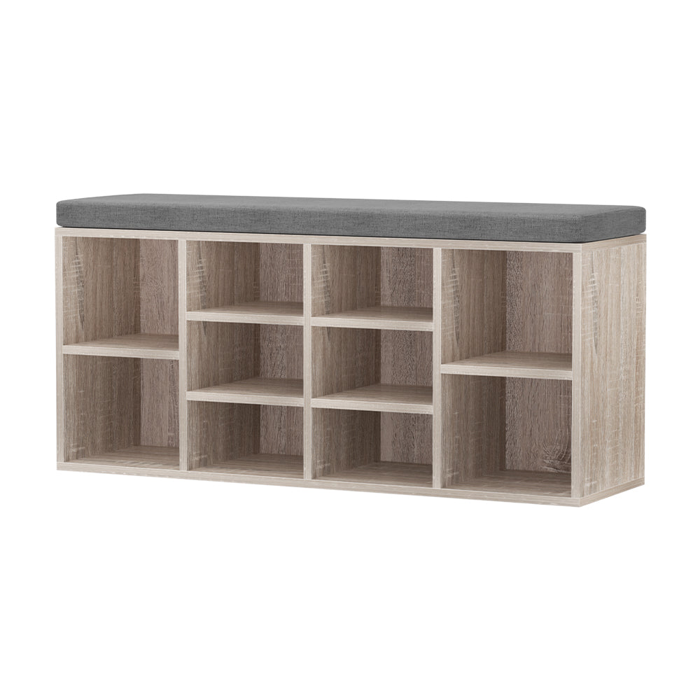 Oak shoe storage bench with grey cushion three-quarter view all 10 open cubbies empty on white background