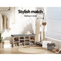 Oak shoe bench with grey cushion loaded with shoes in dressing room lifestyle garment rack sun hat stylish match text