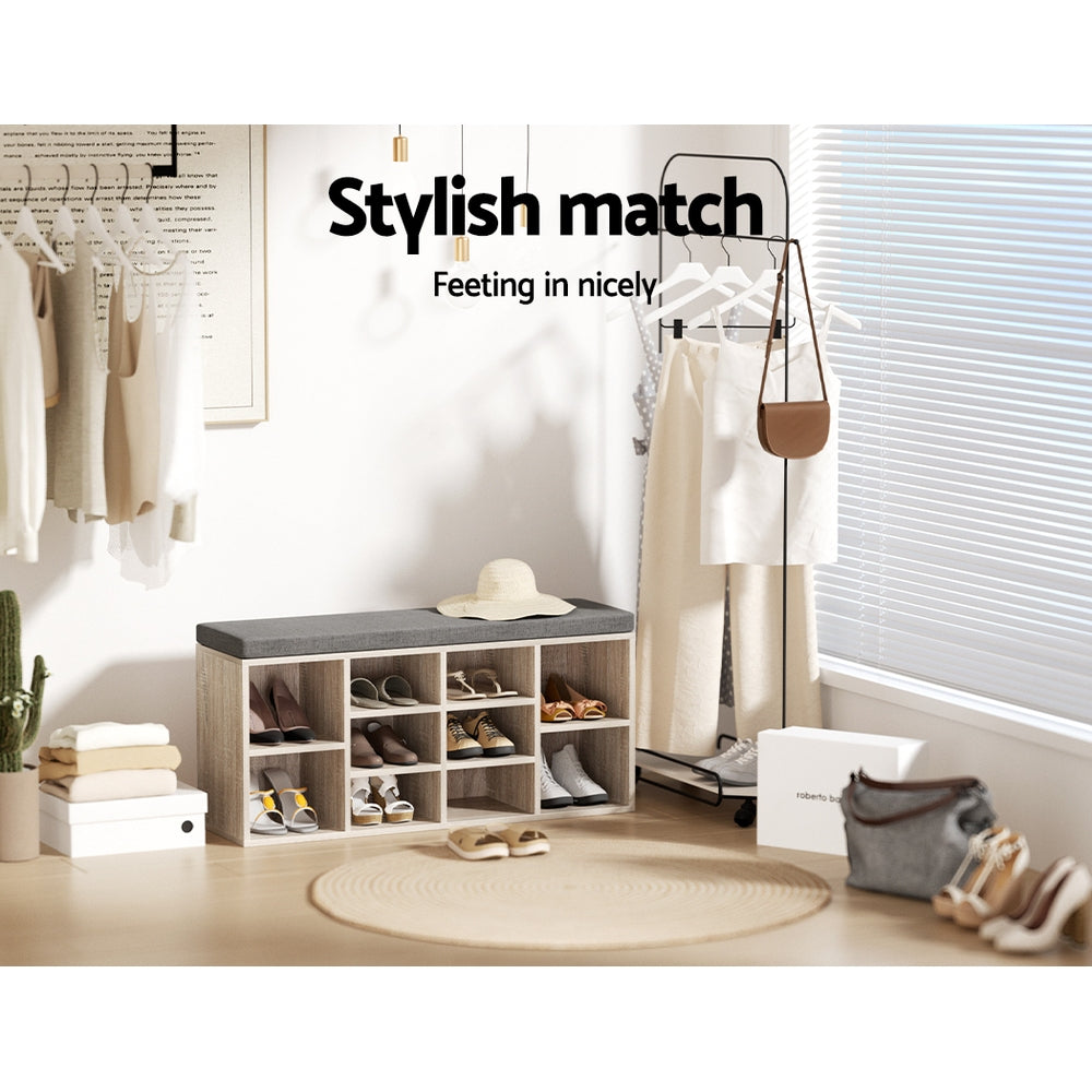 Oak shoe bench with grey cushion loaded with shoes in dressing room lifestyle garment rack sun hat stylish match text